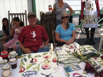 Bill Jones and Julie Howard sold fig preserves (made by Julie) and fig design dish towels and aprons (by Hatteras Island artist Vicki Lowe) to benefit Ocracoke Preservation Society.